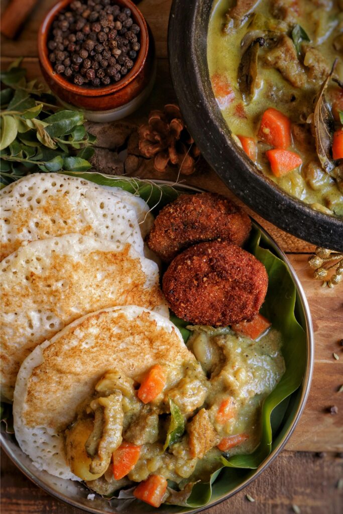 Golden brown thosei stack beside spicy lentil curry