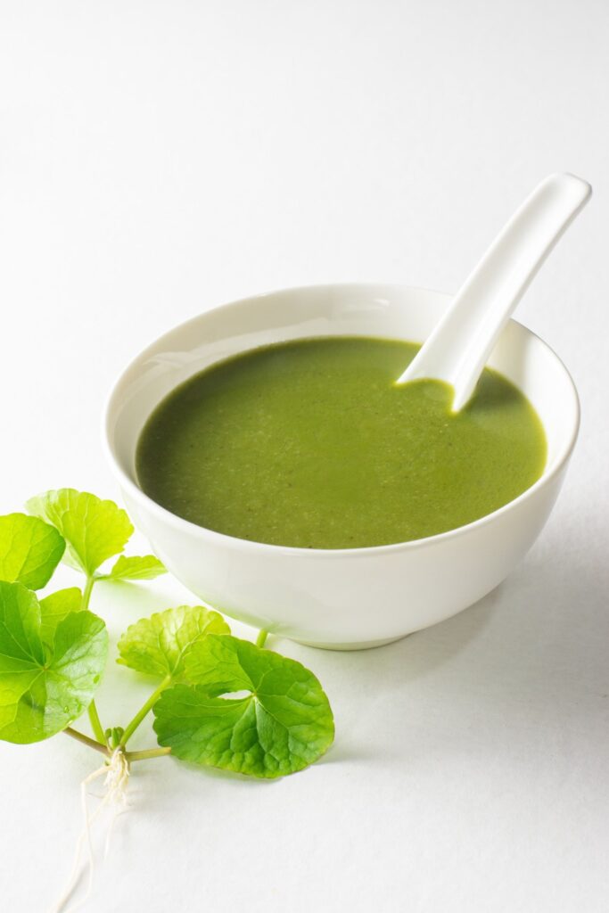 bowl of traditional kola kanda with fresh herbs
